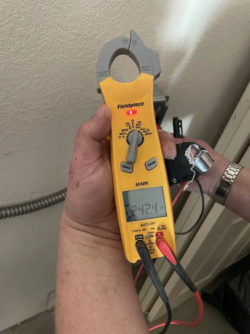 Voltage testing with clamp meter during Ceiling Fan Installation in East Hampton